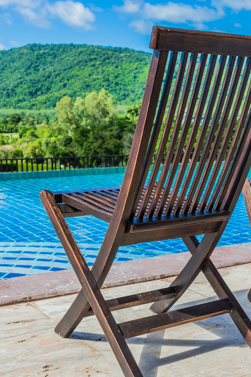 Wooden Lounge Chair by Infinity Pool with Mountain View