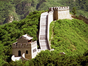 Great Wall of China winding through lush green mountains