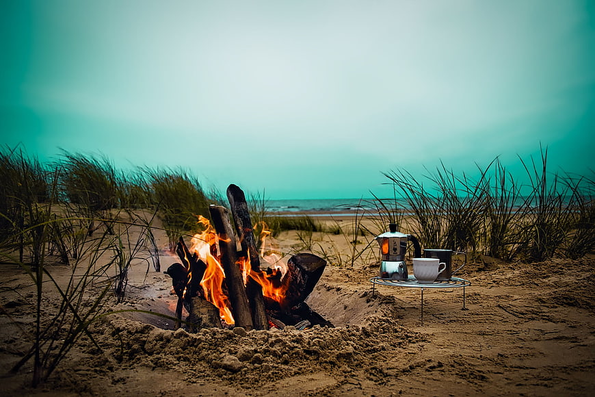 Beach Campfire with Coffee Setup at Dusk