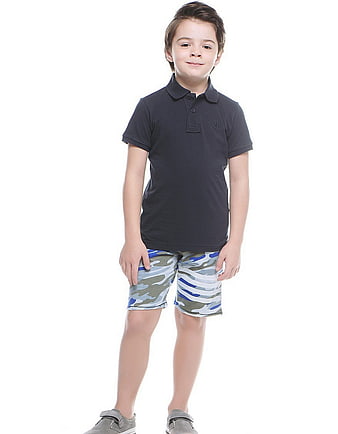 Young boy in navy polo and camouflage shorts