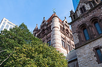 Low angle view of historic stone church architecture with blue sky