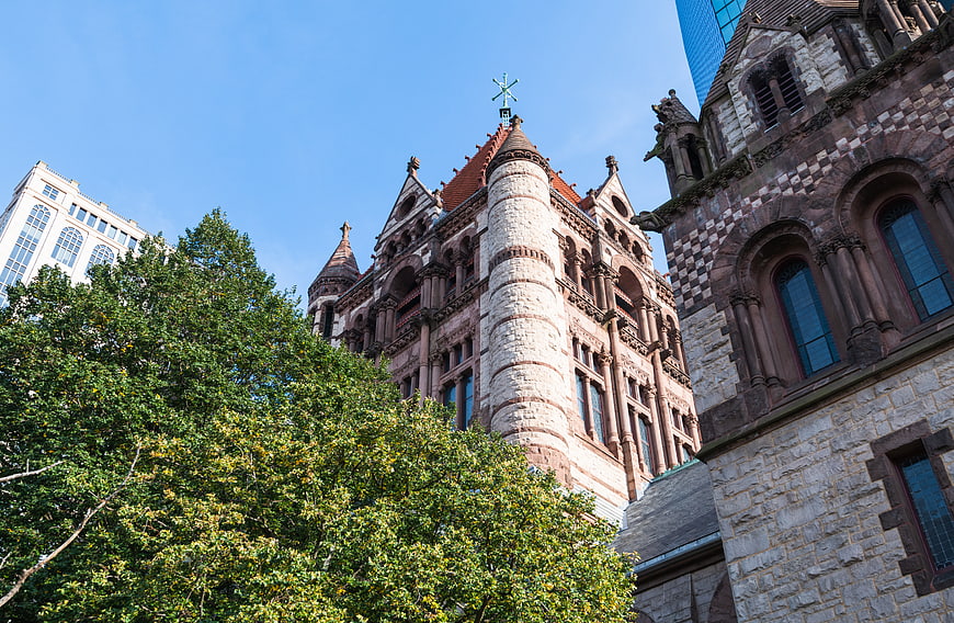 Low angle view of historic stone church architecture with blue sky