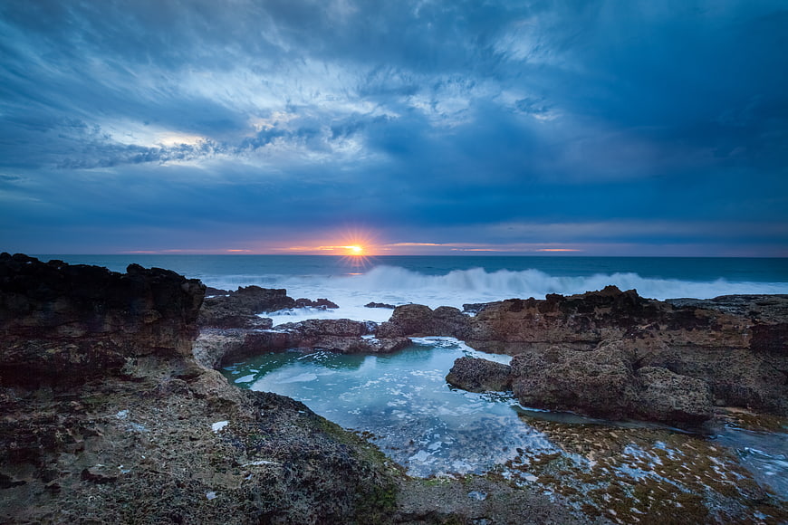 Dramatic Sunset Over Rocky Coastal Tide Pool