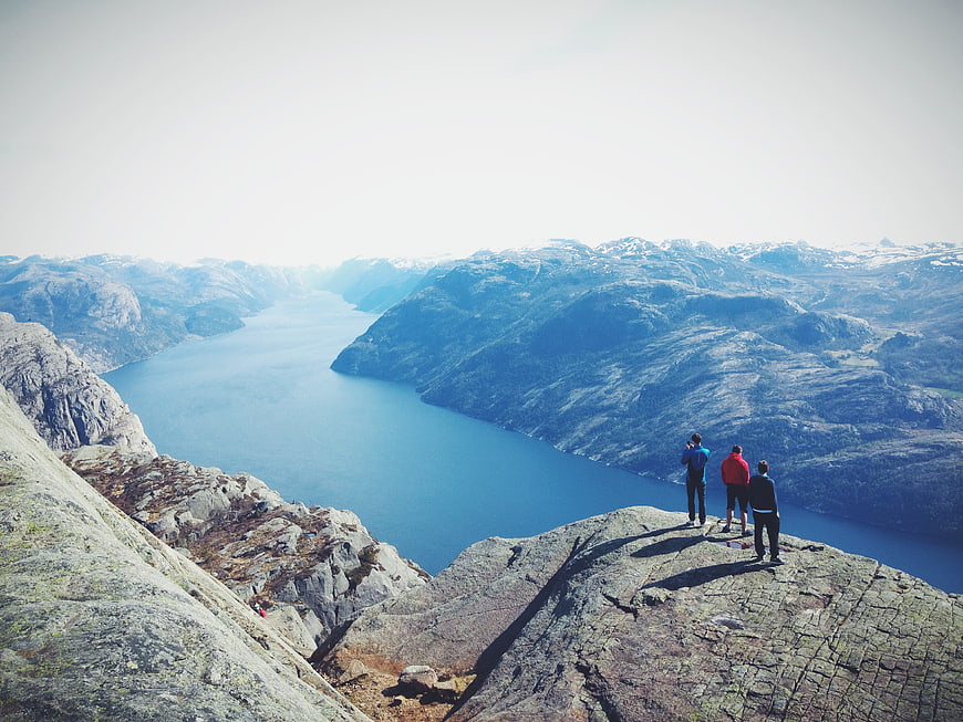 Hikers on Preikestolen overlooking Lysefjord in Norway