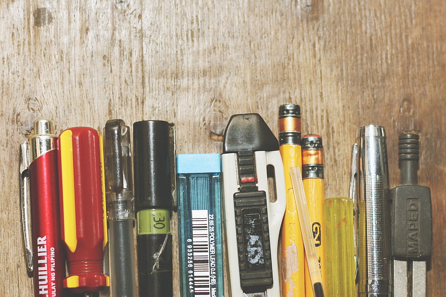 Assorted Stationery and Tools on Wooden Background