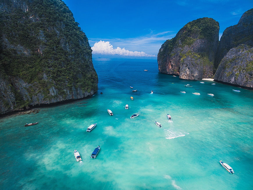 Aerial View of Turquoise Lagoon with Boats and Limestone Cliffs