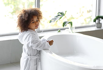 Cute Child in White Robe by Bathtub