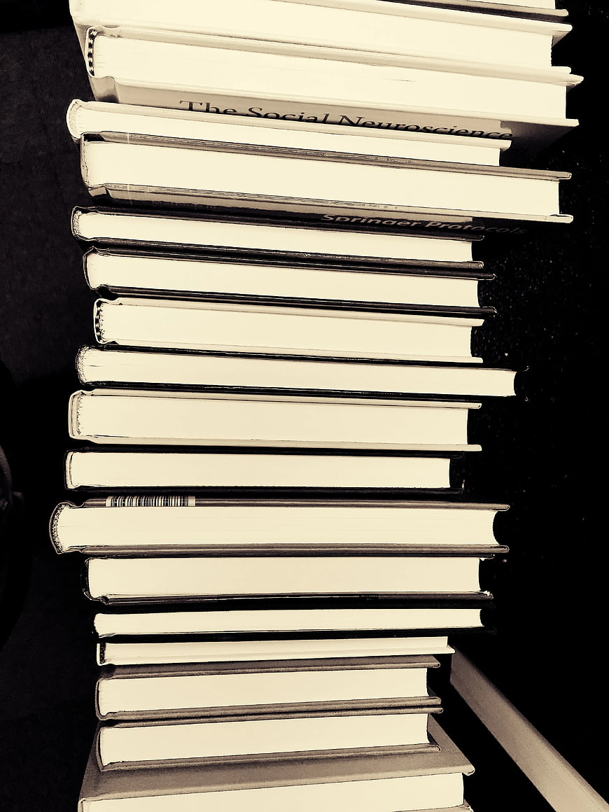 Stack of Academic Books on Dark Background