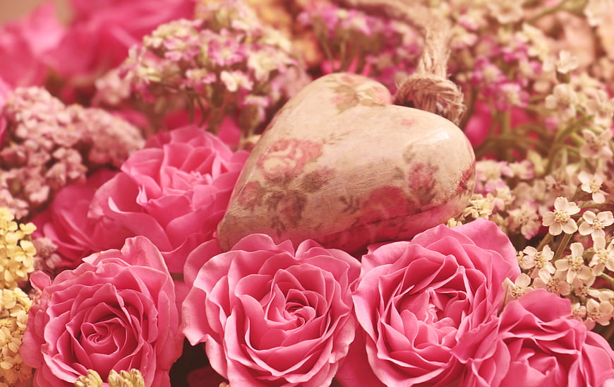 Pink Roses And Heart-Shaped Stone In Romantic Floral Arrangement