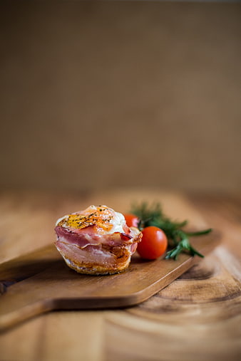 Bacon-Wrapped Egg Cup on Wooden Board with Tomatoes