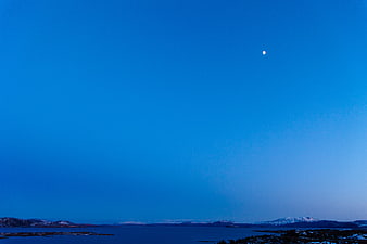 Serene Blue Twilight Sky Over Snowy Coastal Landscape