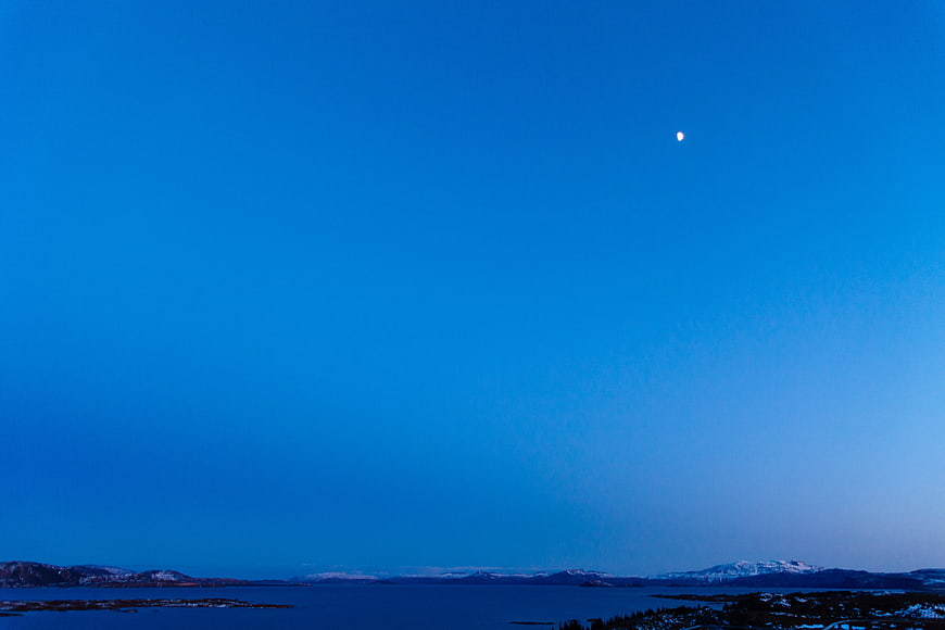 Serene Blue Twilight Sky Over Snowy Coastal Landscape