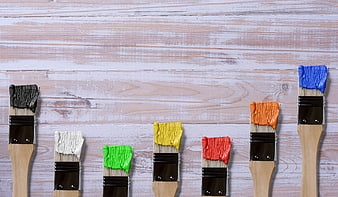Colorful Paint Brushes on Whitewashed Wooden Background