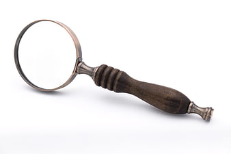 Antique wooden magnifying glass with brass rim on white background