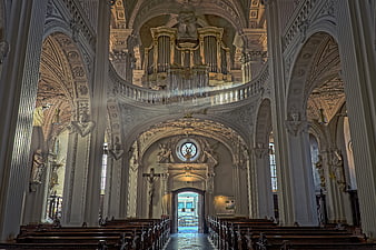 Baroque church interior with organ and columns