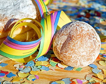 Carnival Donuts With Colorful Streamers And Confetti On Wooden Surface