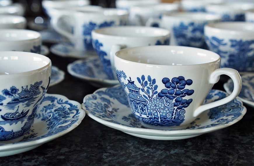 Blue and white patterned porcelain teacups on saucers