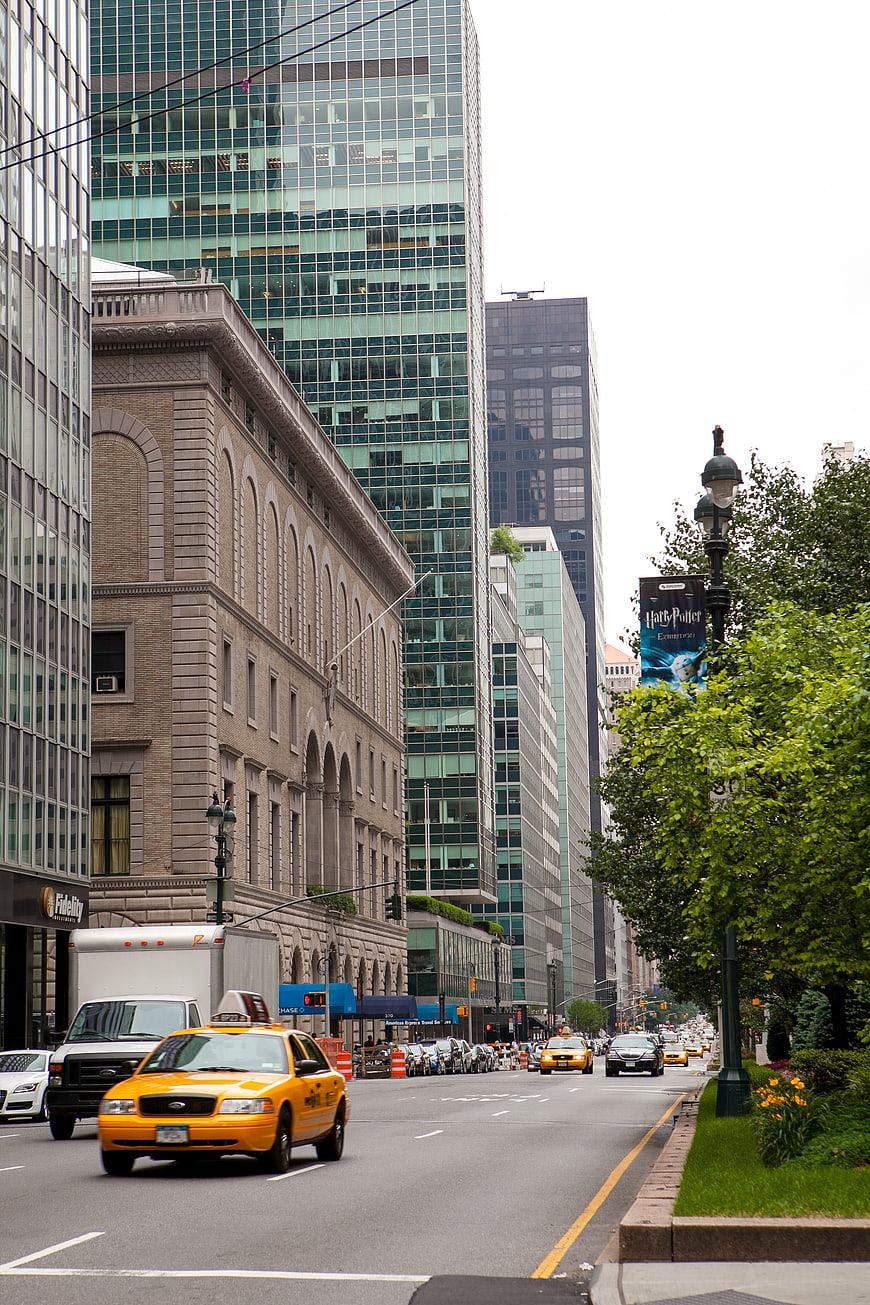 Yellow Taxi Driving on Busy Downtown City Street