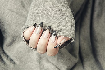 Close-up of hand with black and white gel nail art