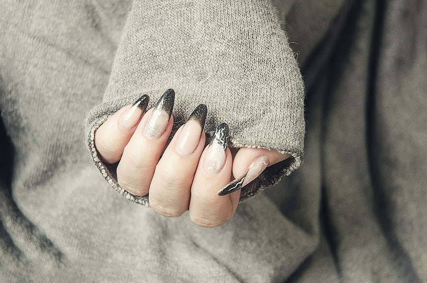 Close-up of hand with black and white gel nail art