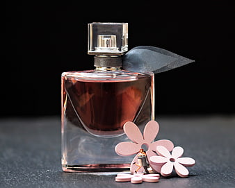Pink perfume bottle with miniature lovers and flowers