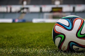 Close-up of colorful soccer ball on green grass field