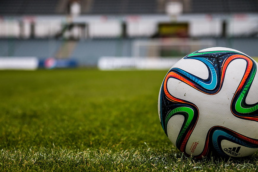 Close-up of colorful soccer ball on green grass field