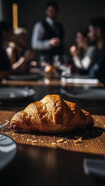 Golden Croissant on Wooden Table in Elegant Restaurant