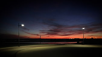 Empty Street at Dusk with Streetlights and Sunset Sky