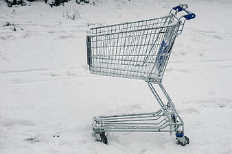 Empty Shopping Cart Abandoned in Snowy Field