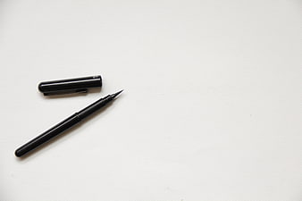 Black Calligraphy Pen on White Textured Paper Background