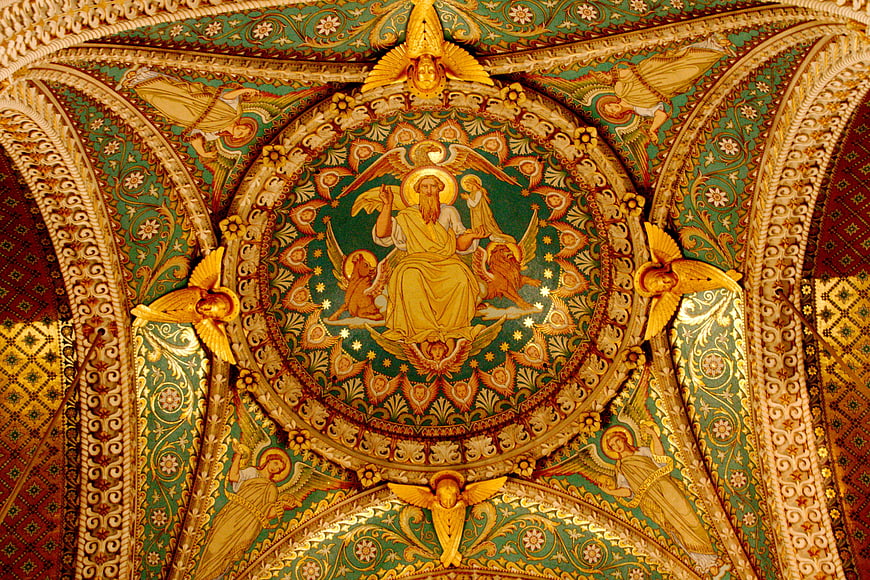 Ornate golden religious ceiling fresco with angels and divine figure