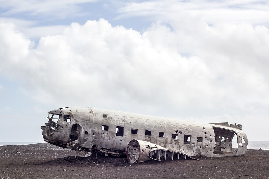 Crashed DC-3 airplane wreck on black sand beach
