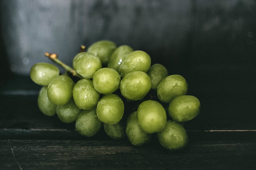 Fresh Green Grapes on Dark Wooden Surface