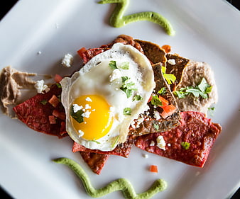 Overhead shot of chilaquiles with fried egg and salsa verde