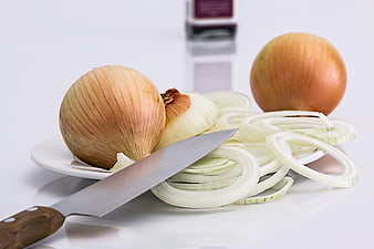 Fresh Yellow Onions and Sliced Rings with Chef Knife