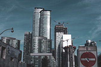 Modern Skyscrapers and Construction Cranes in Urban Cityscape