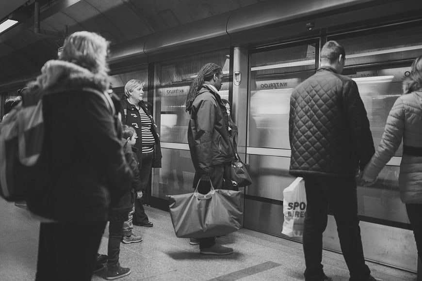Commuters Waiting on Subway Platform in Black and White