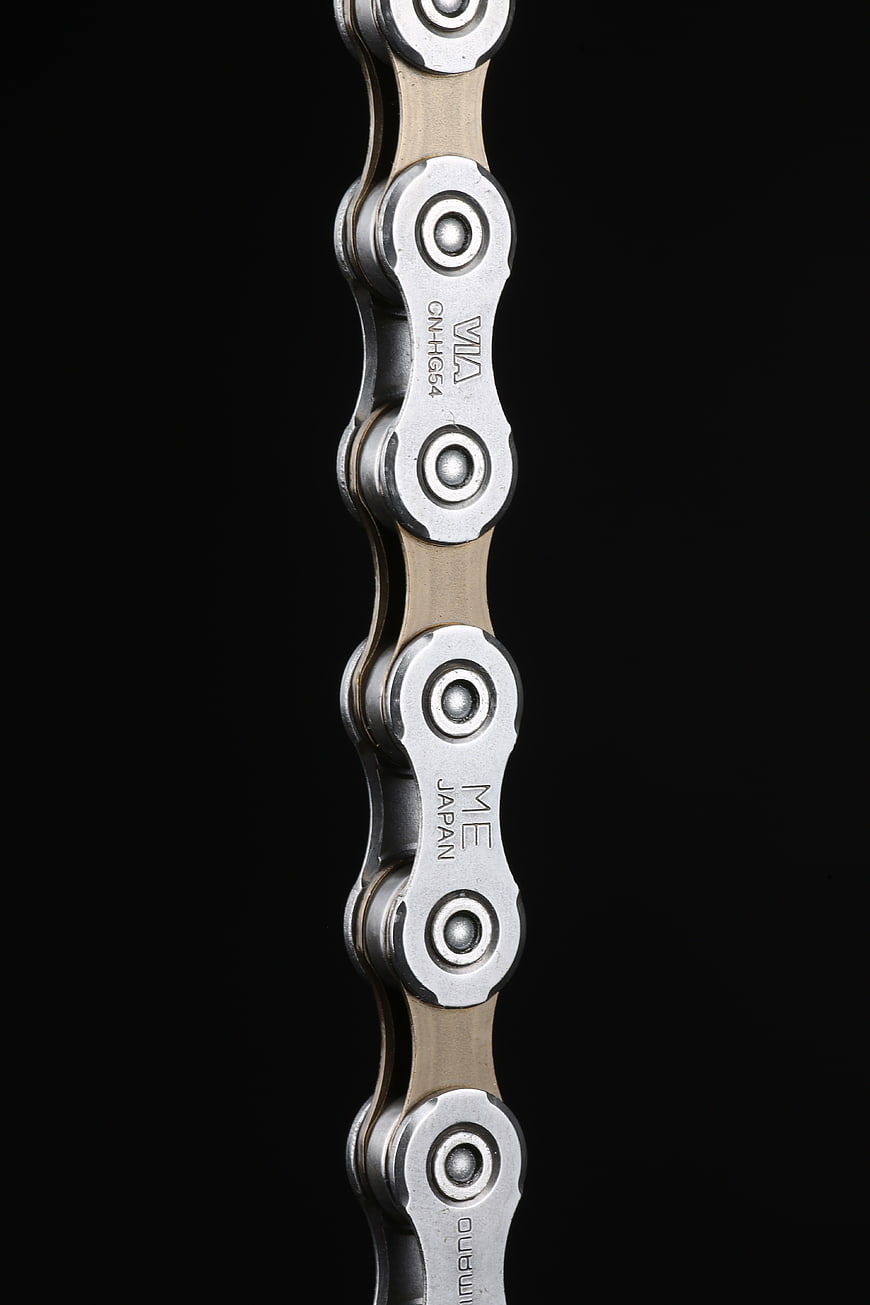 Close-up of Shimano bicycle chain on black background