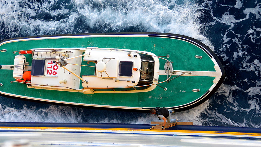 Aerial view of green pilot boat docking at ferry