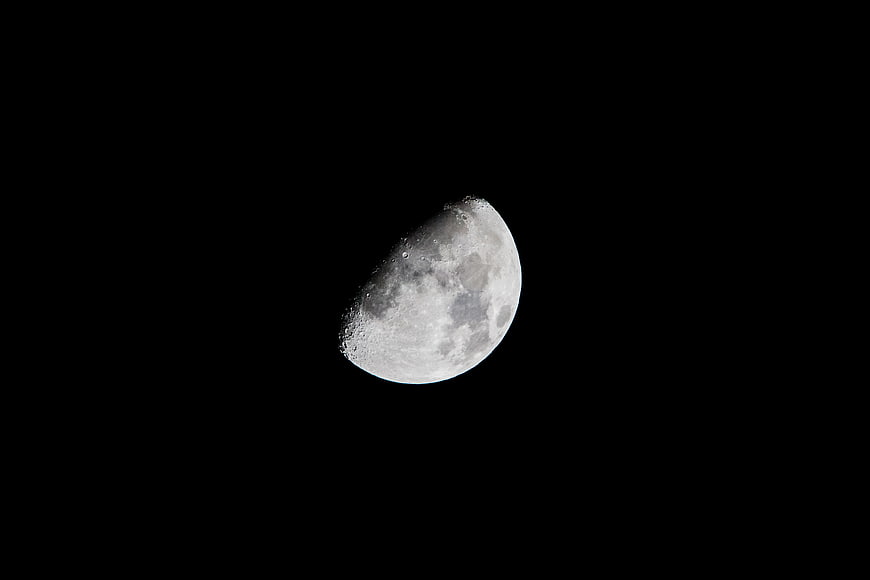 High-Resolution Crescent Moon with Craters Against Black Sky