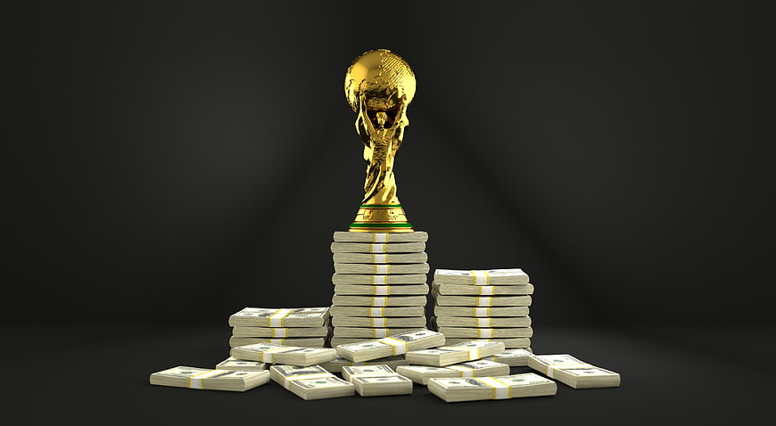 Golden World Cup Trophy on Stacks of Cash