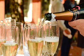 Pouring Champagne into Glasses at Outdoor Celebration