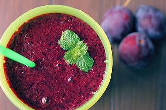 Top-Down View of Plum Smoothie Garnished with Mint Leaves