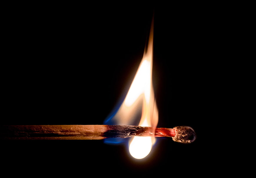 Burning Matchstick on Black Background