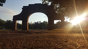 Low angle view of stone archway at golden hour