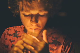 Cinematic portrait of young man smoking in warm light