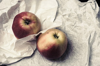 Two Red Apples on Crumpled White Paper