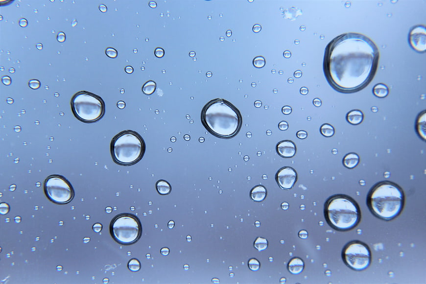 Close-up of water droplets on a blue surface