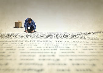 Miniature man crawling on giant text with cardboard box